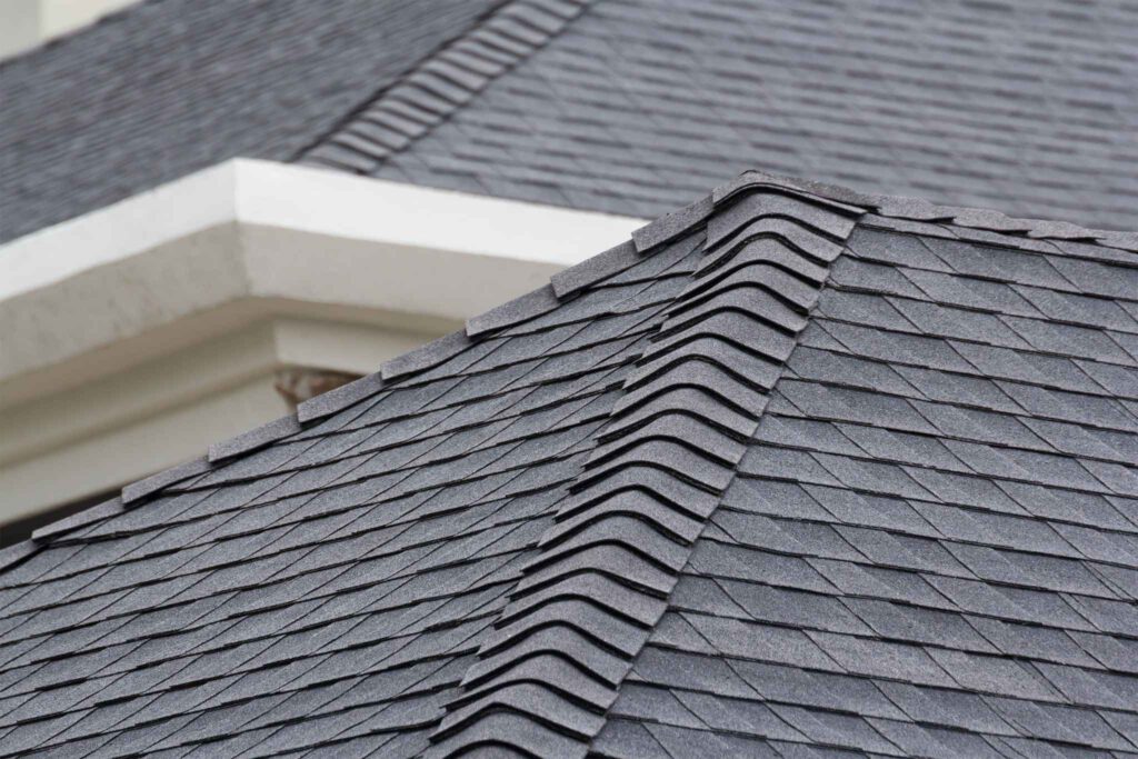 Dark gray roof shingles installed on white house