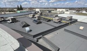 commercial roofing drainage system on flat roof building
