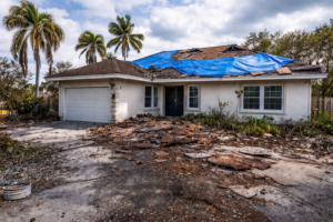Hurricane-damaged roof with tarp in Tampa FL showing need for roof replacement financing