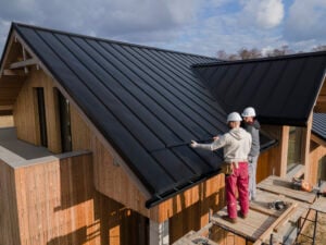 workers-installing-black-roof-on-a-residential-home-to-improve-energy-efficiency